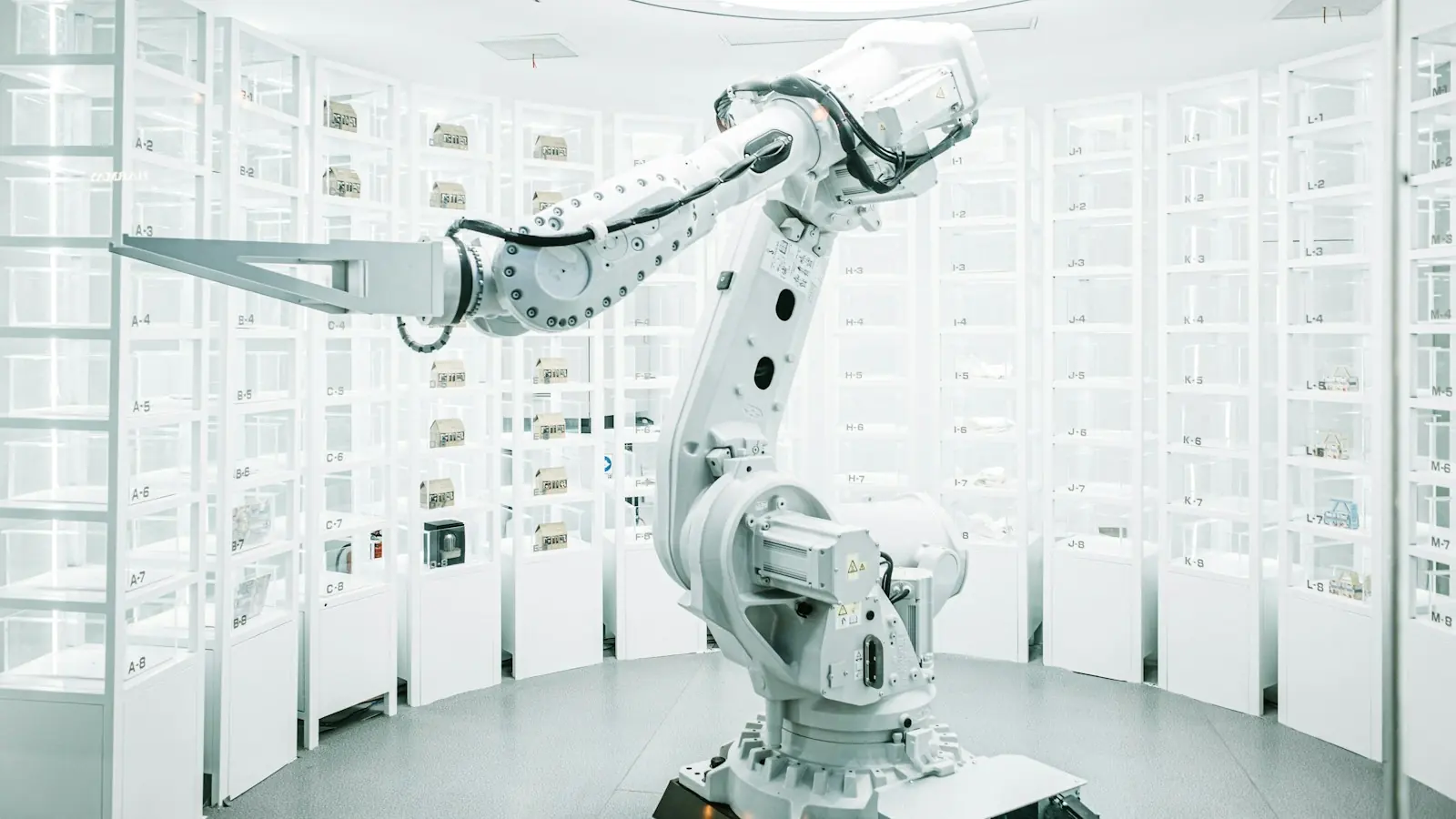 White industrial robot arm – automation of business processes