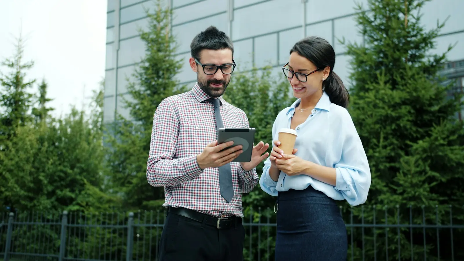 Two colleagues reviewing company data on a tablet