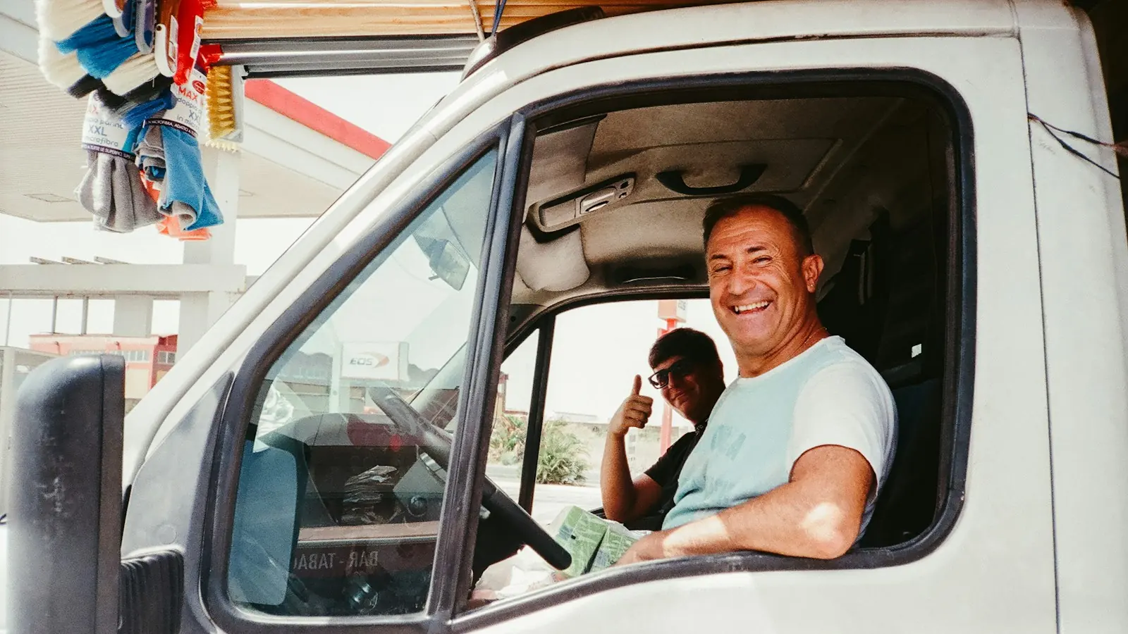 Smiling van driver in the cab of a company vehicle